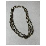 Silver three strand bracelet marked Sterling.