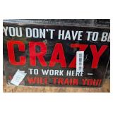 CRAZY TO WORK HERE Metal Sign. New in package