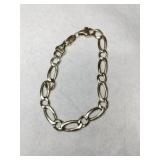 Gold Figaro men's bracelet marked 14k.     .575oz