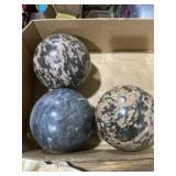 Three solid stone balls, 4 inches round