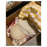 Variety of doilies and other fabrics and table
