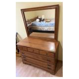 Wood dresser with attached framed mirror and