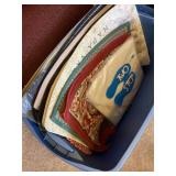 Tote full of welcome mats and other rugs