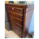 Five-drawer wood dresser in a cherry finish 54'