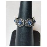 Silver flowered blue stone ring.   size 6.