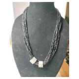 Multi-strand black beaded necklace with clear