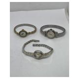 3 ladies' metal analog wristwatches one is