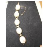 Gold tone mother of pearl link bracelet safety