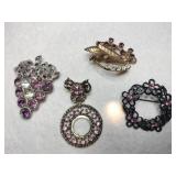 4 purple rhinestone brooches (one missing two