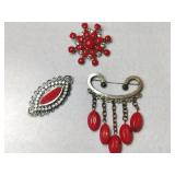 3 silvertone Redstone brooches