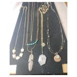 Four gold tone necklaces