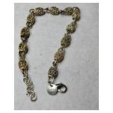 Gold tone silver link bracelet marked 925.