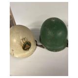 Two military helmets one is auxiliary police