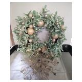 Decorative wreath with wall snowflake hanging.