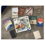 Old military books in a decorative tin container