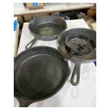 Four cast-iron pans