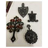 4 cast-iron trivets