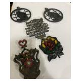 Collection of aluminum and cast-iron trivets