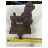 Cast iron Santa on a tractor stocking holder