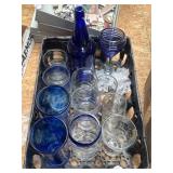 Crate of mixed blue and clear glassware