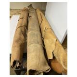 Three rolls of tanned leather