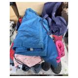 Mix of kid clothes, boots, queen size sheets, and