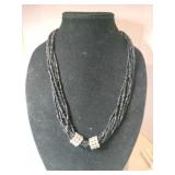 Black 6 strand beaded necklace 2 clear Stone