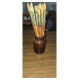 Amber glass jar with paintbrushes