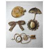 Gold tone brooches hat ,umbrella, heart ,bow
