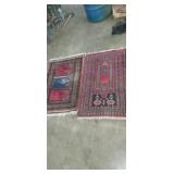2 red small ornate hand tied rugs 24x40 23x28in