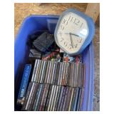 Tote of cds, wall clock, cassettes, and cassette