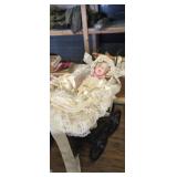 Small wooden wicker doll stroller with porcelain