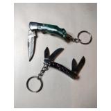 2 green and blue handled pocket knife keychains
