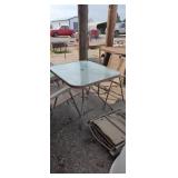Glass top patio table with 4 matching chairs some