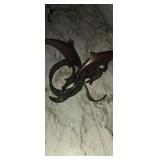 Copper dolphin sculpture has broken piece