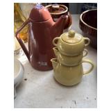 large red teapot and a yellow stacked teapot set