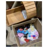 Wooden doll cradle and box of doll clothes
