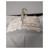 Group of 31 padded satin clothes hangers. Photo