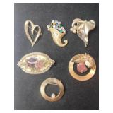 6 gold tone brooches