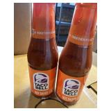 Two jars of Taco Bell hot sauce