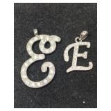 2 silver tone ' E' clearstone pendants