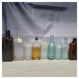 9 glass bottles various colors and sizes