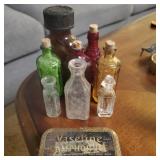 Vintage miniature bottles and antique tin.