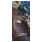 Kinston rolling glass top coffee table with 2