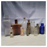 12 glass bottles various sizes and colors