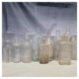 10 glass bottles various sizes and colors