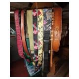 Lot of leather and fabric guitar straps. Some