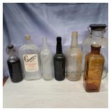 7 assorted glass bottles