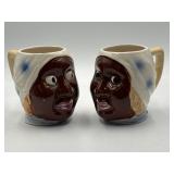 Pair of black Americana character mugs marked