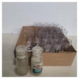 25 plastic shot glasses and 2 glass spice bottles